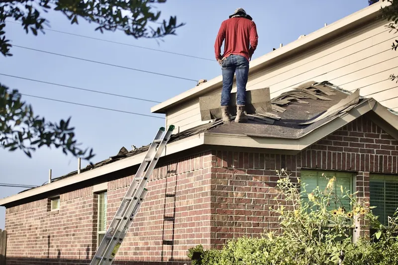 Professional roofer working on a residential roof in Cahuenga Pass